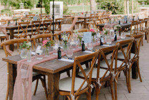 X-back wood chairs at rectangular wood farm table set for dinner